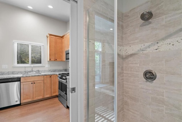 bathroom featuring a healthy amount of sunlight, an enclosed shower, and wood-type flooring