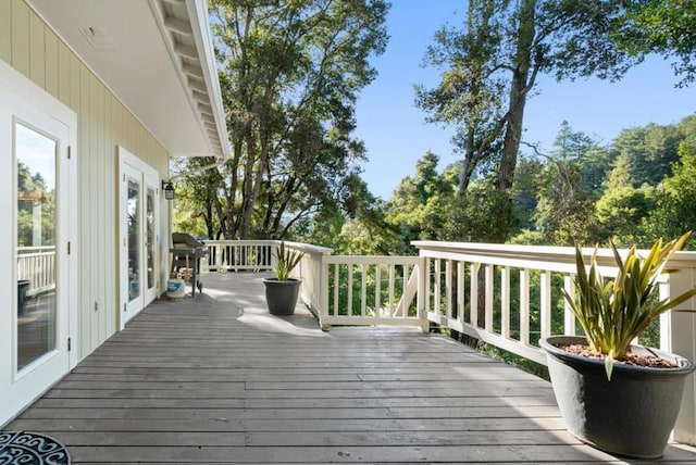 wooden deck featuring area for grilling