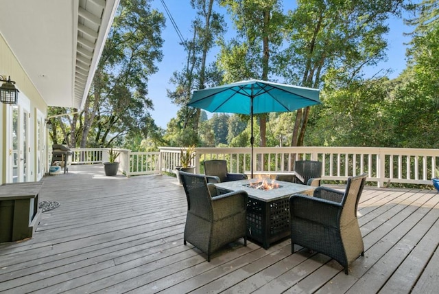 wooden terrace featuring a fire pit