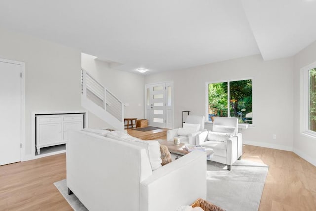 living room featuring light wood-type flooring and a healthy amount of sunlight