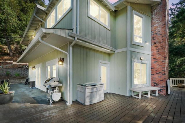 wooden deck with a grill