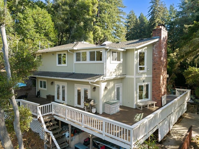 back of house with french doors and a deck