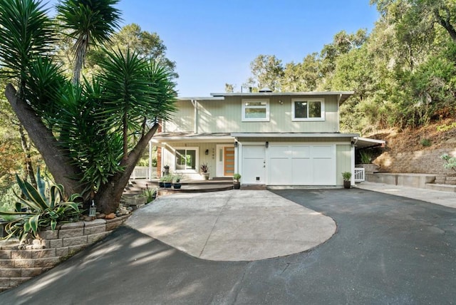 view of property featuring covered porch and a garage