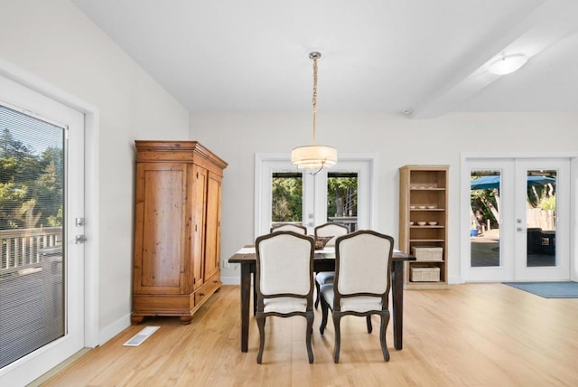 dining space with light wood-type flooring and french doors