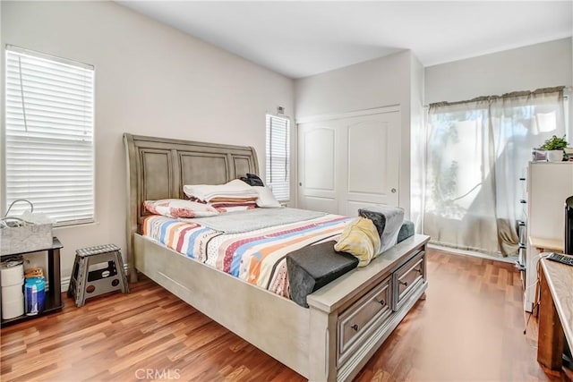 bedroom with a closet and light hardwood / wood-style flooring