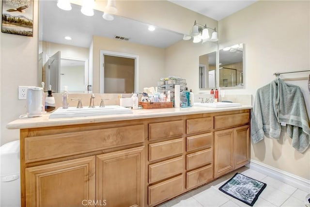 bathroom featuring tile patterned flooring, vanity, and an enclosed shower