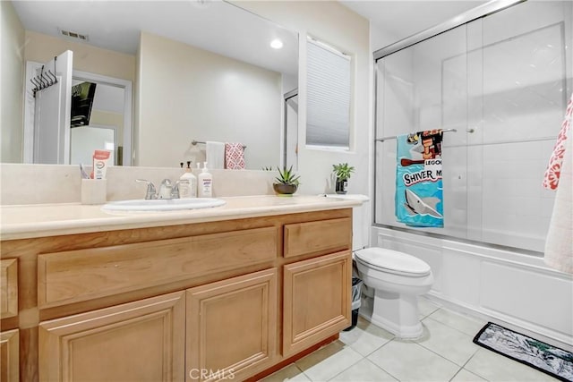 full bathroom with tile patterned flooring, vanity, toilet, and combined bath / shower with glass door