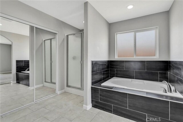 bathroom with tile patterned floors and plus walk in shower