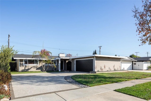 ranch-style home with a garage and a front lawn