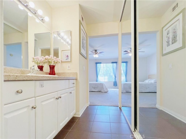 bathroom featuring tile patterned flooring and vanity