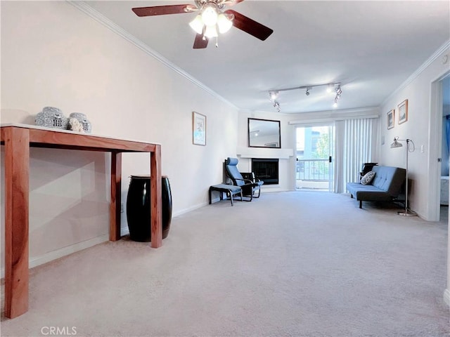 living area with carpet, ceiling fan, and crown molding