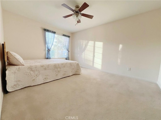 carpeted bedroom featuring vaulted ceiling and ceiling fan