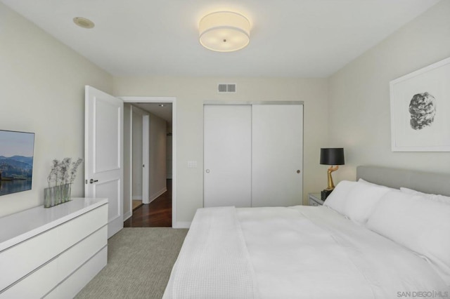 bedroom featuring light carpet and a closet