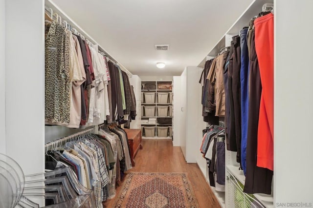 spacious closet featuring hardwood / wood-style flooring