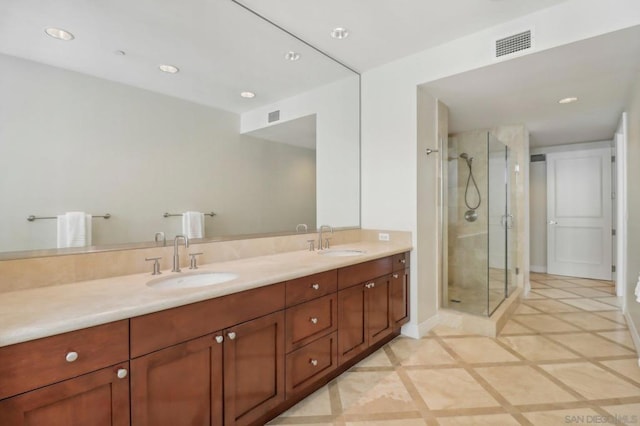 bathroom featuring vanity and a shower with shower door