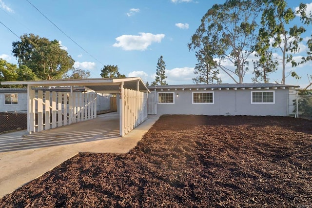 back of house with a carport