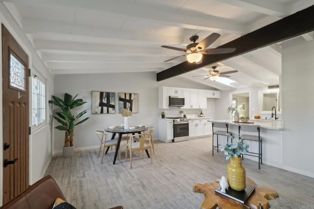 living room with lofted ceiling with beams, ceiling fan, and light hardwood / wood-style flooring