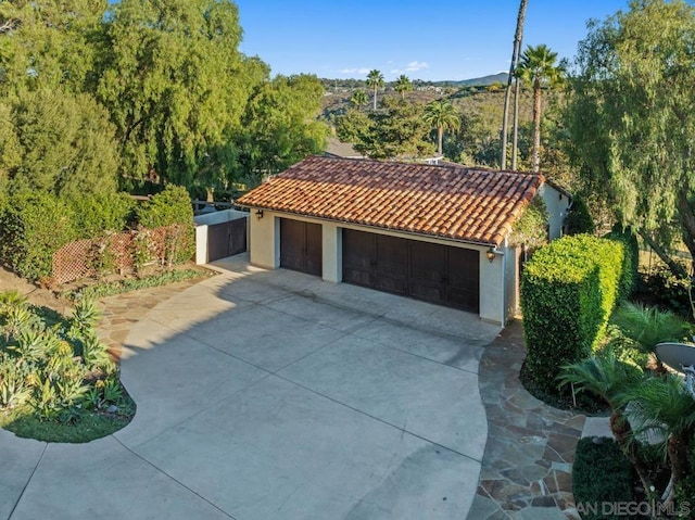 mediterranean / spanish-style home with a garage