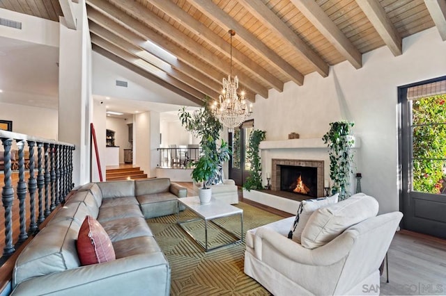 living room featuring light wood-type flooring, beam ceiling, high vaulted ceiling, wooden ceiling, and a notable chandelier