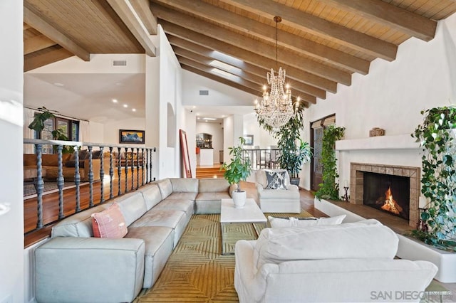 living room featuring wooden ceiling, beamed ceiling, high vaulted ceiling, hardwood / wood-style floors, and a chandelier