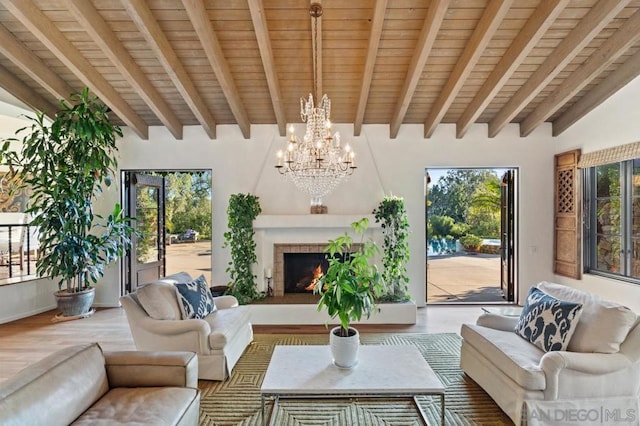 sunroom / solarium featuring a chandelier, beam ceiling, and wood ceiling