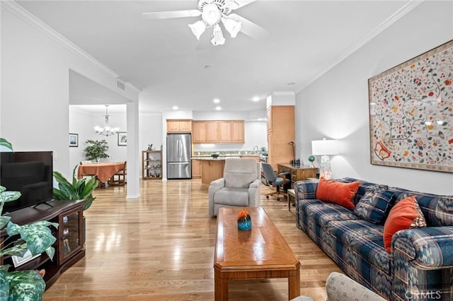 living room featuring ceiling fan with notable chandelier, crown molding, and light hardwood / wood-style flooring