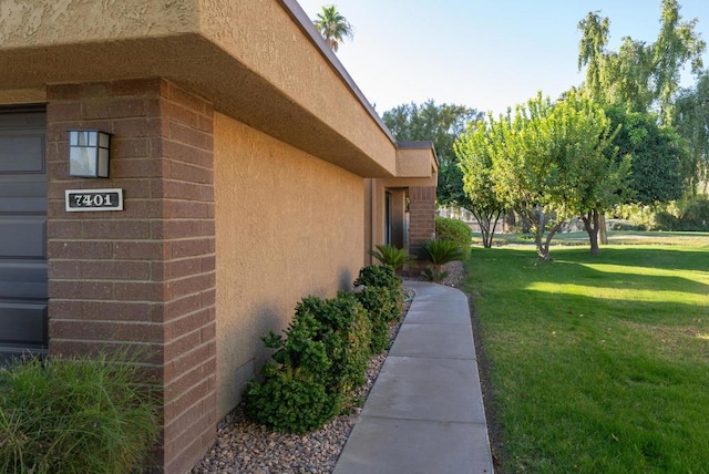 view of side of home featuring a lawn