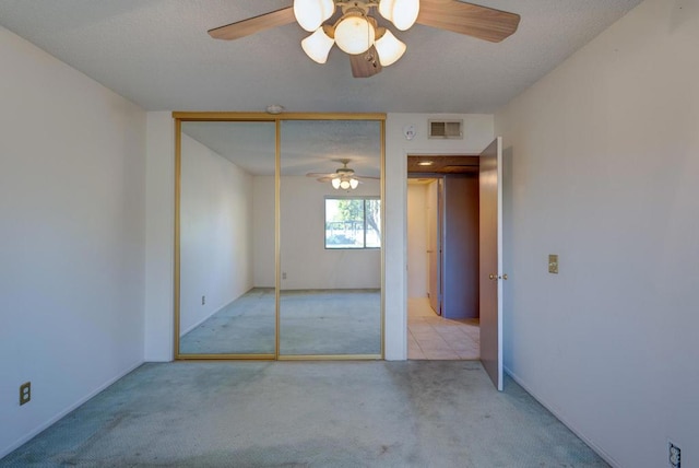 spare room featuring ceiling fan and light colored carpet