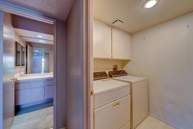 washroom with cabinets and separate washer and dryer