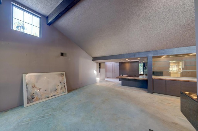 unfurnished living room featuring high vaulted ceiling, a wealth of natural light, light carpet, and beamed ceiling