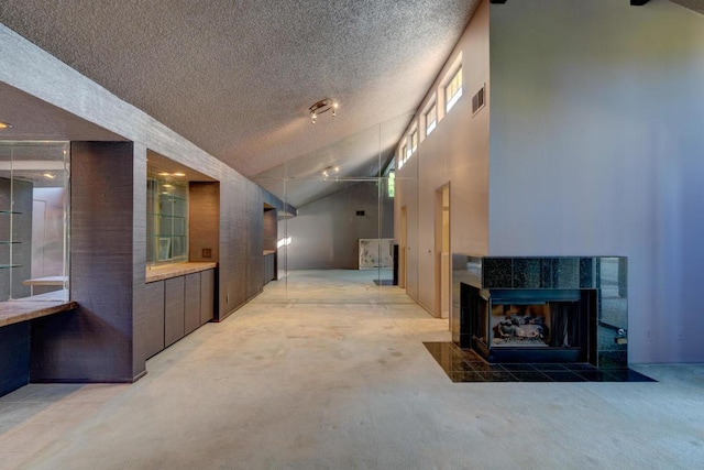 hall with lofted ceiling, a textured ceiling, and carpet flooring