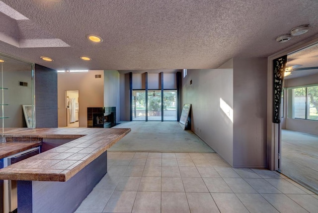 hall with light colored carpet and a healthy amount of sunlight