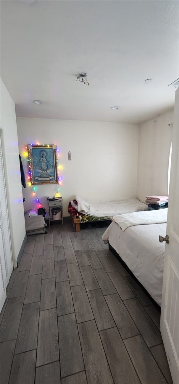 bedroom featuring dark wood-type flooring