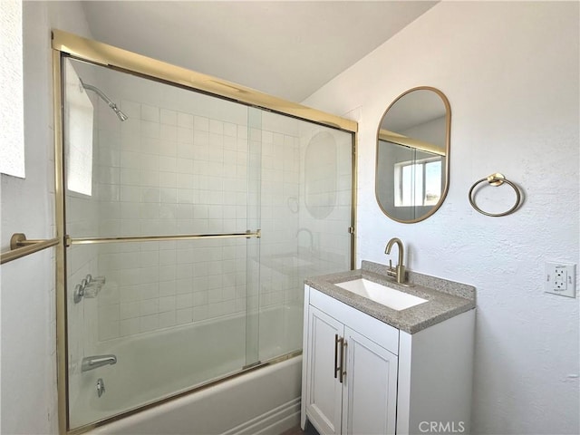 bathroom with vanity and bath / shower combo with glass door