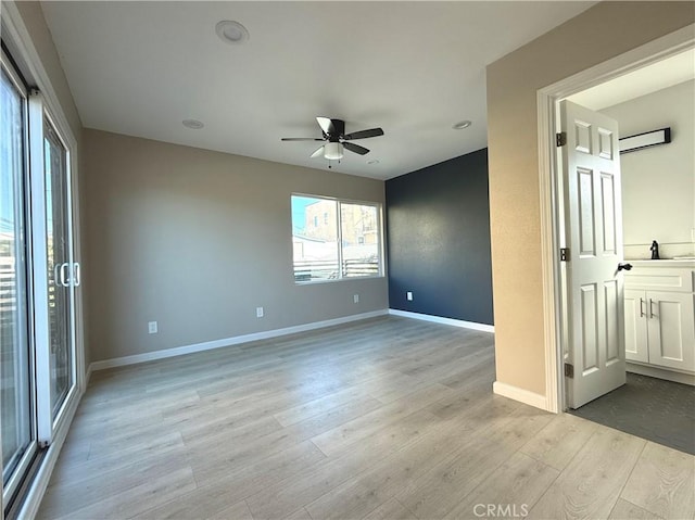 spare room with ceiling fan and light hardwood / wood-style floors