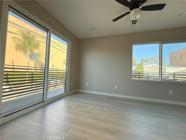 unfurnished room featuring ceiling fan and light hardwood / wood-style flooring