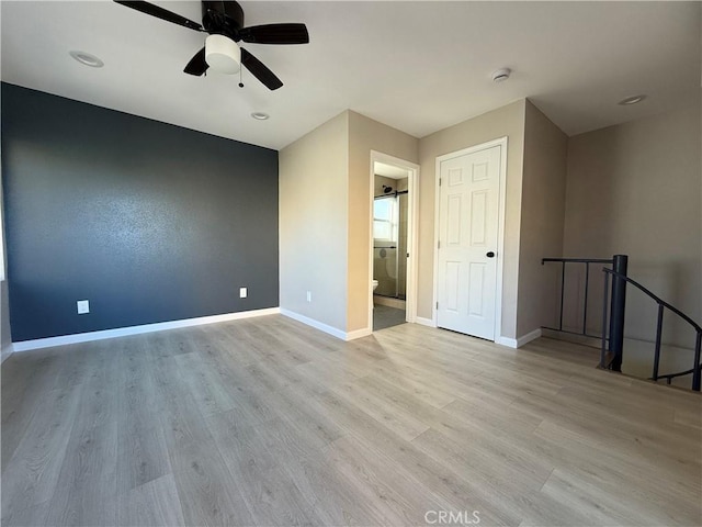 empty room with light hardwood / wood-style floors and ceiling fan