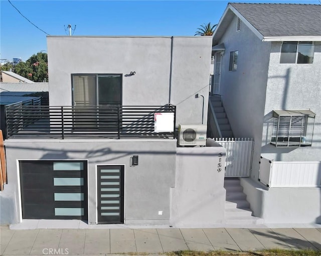 back of house with a balcony and ac unit