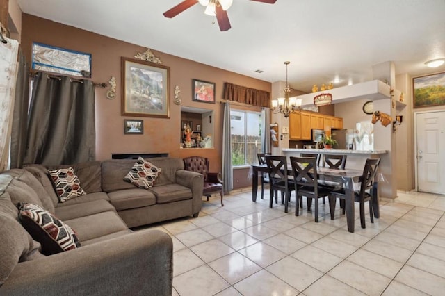 tiled living room featuring ceiling fan with notable chandelier