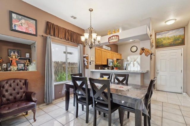 dining room featuring an inviting chandelier and light tile patterned floors