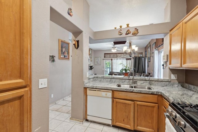 kitchen with sink, light tile patterned floors, ceiling fan, white dishwasher, and stainless steel range oven