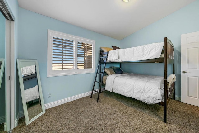 carpeted bedroom featuring lofted ceiling