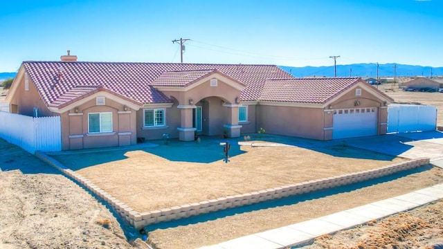 view of front of home with a mountain view and a garage