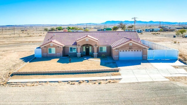 view of front of home with a garage and a mountain view