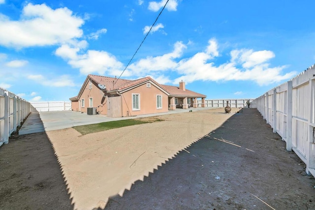 rear view of property with central air condition unit