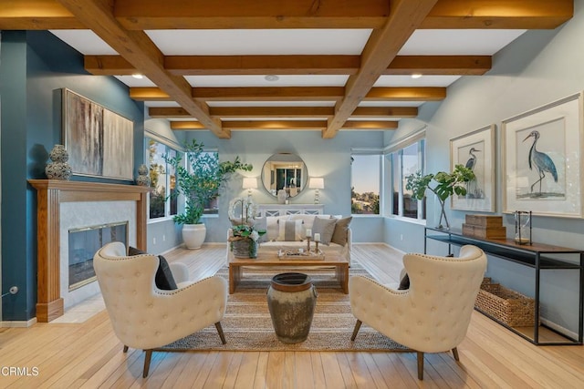 sitting room featuring light hardwood / wood-style floors, beam ceiling, and coffered ceiling