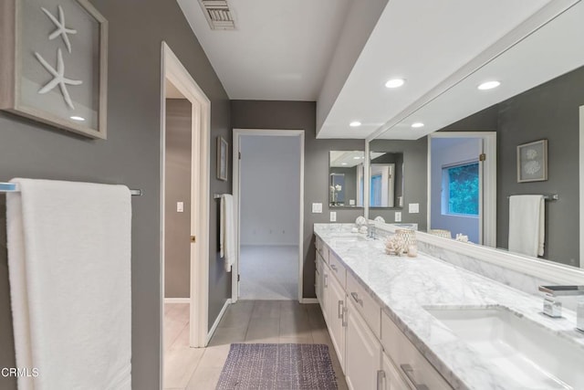 bathroom with tile patterned flooring and vanity