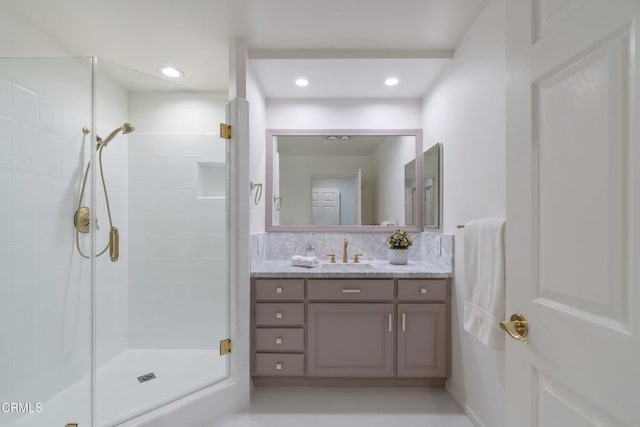 bathroom featuring vanity and an enclosed shower