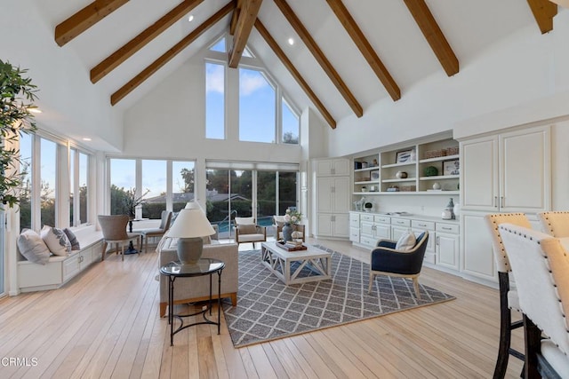 living room featuring beam ceiling, light hardwood / wood-style floors, and high vaulted ceiling