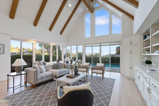 sunroom with vaulted ceiling with beams